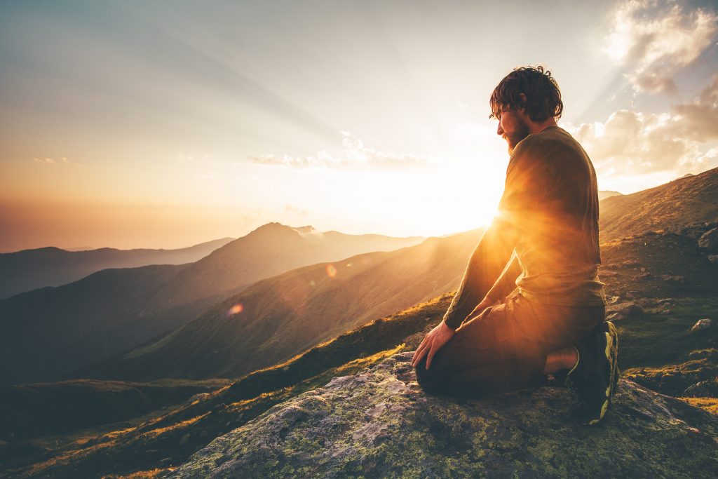 Man relaxing at sunset mountains Travel Lifestyle spiritual awak Man relaxing at sunset mountains Travel Lifestyle spiritual awakening emotional meditating concept vacations outdoor harmony with nature landscape