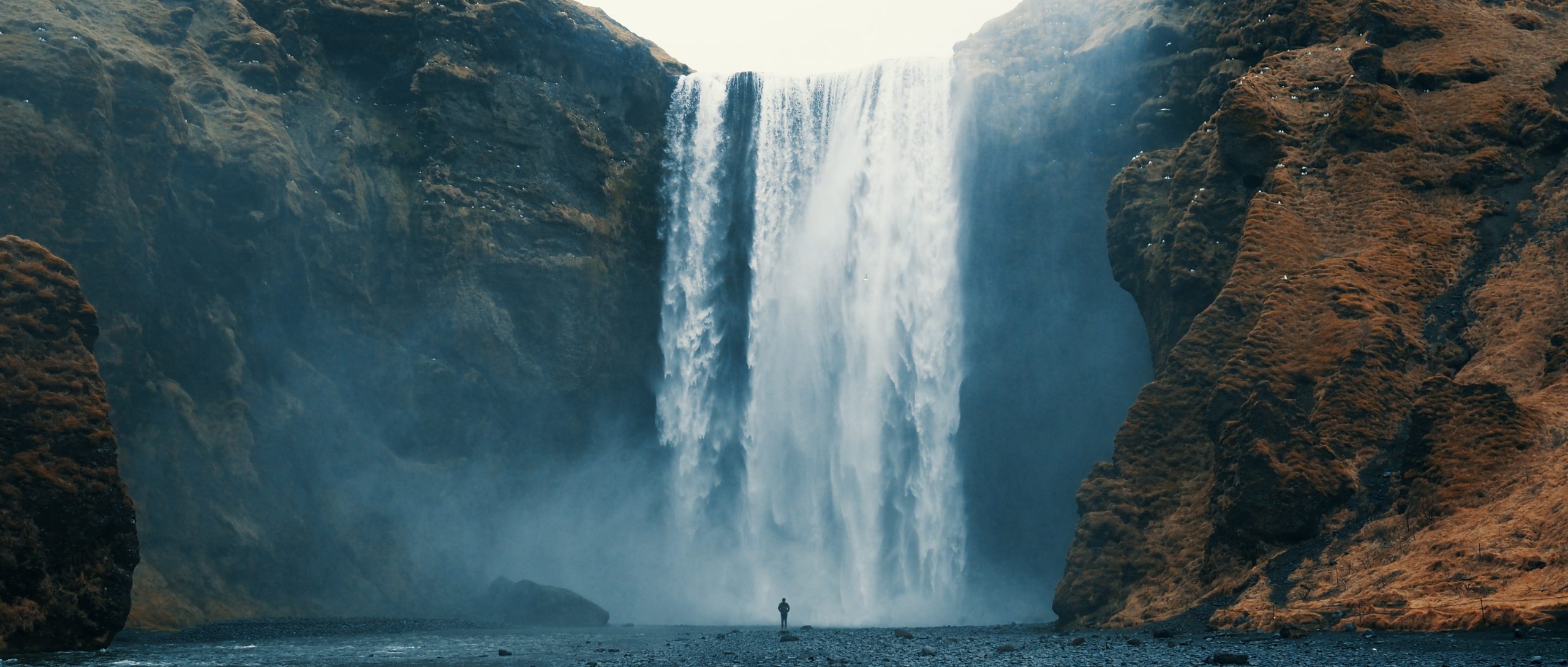 Woman overlooking waterfall at skogafoss, Iceland. Skógafoss, OLYMPUS DIGITAL CAMERA