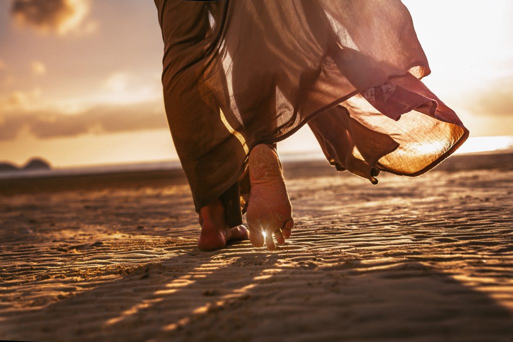 close up of woman feet walking onthe beach at sunset close up of woman feet walking onthe beach at sunset